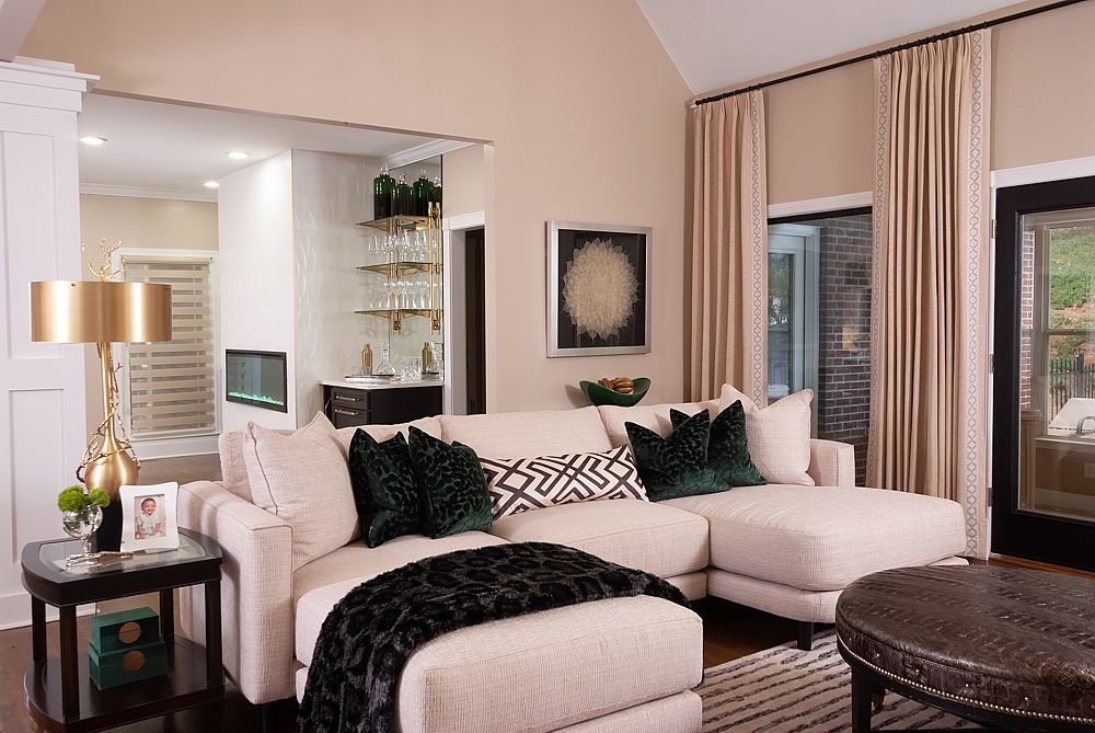 A neutral space that is never dull due to the layered textiles such as the patterned rug, custom draperies, pillows and the insertion of reflective surfaces and lighting. 
